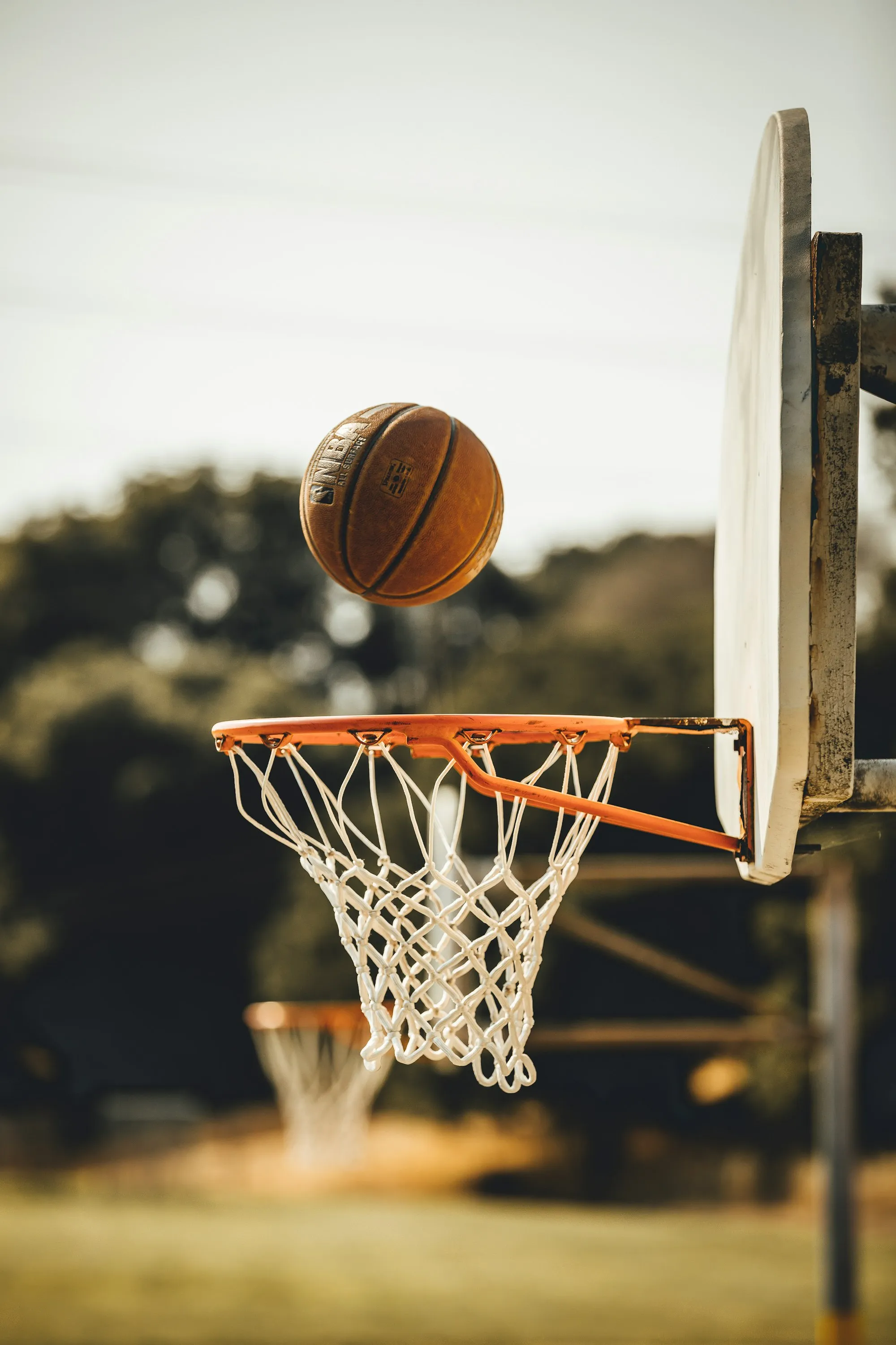 A basketball dropping through the hoop
